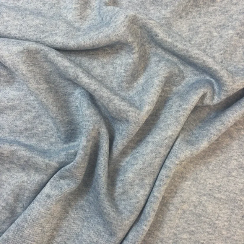 Modrý melírovaný úplet z viskózy – lehce pružný materiál s decentním vzhledem pro pohodlné oblečení.