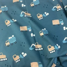 Nepočesaná teplákovina s digitálním potiskem bagrů a stavebních strojů na petrolejovém podkladu, složená do měkkých záhybů. Nepočesaná teplákovina s digitálním potiskem bagrů a stavebních strojů na petrolejovém podkladu, složená do měkkých záhybů.