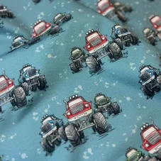 Bavlněný úplet s potiskem monster trucků na modrém podkladu