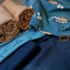 Balíček dětských látek se stavebními stroji a jednobarevnými teplákovinami